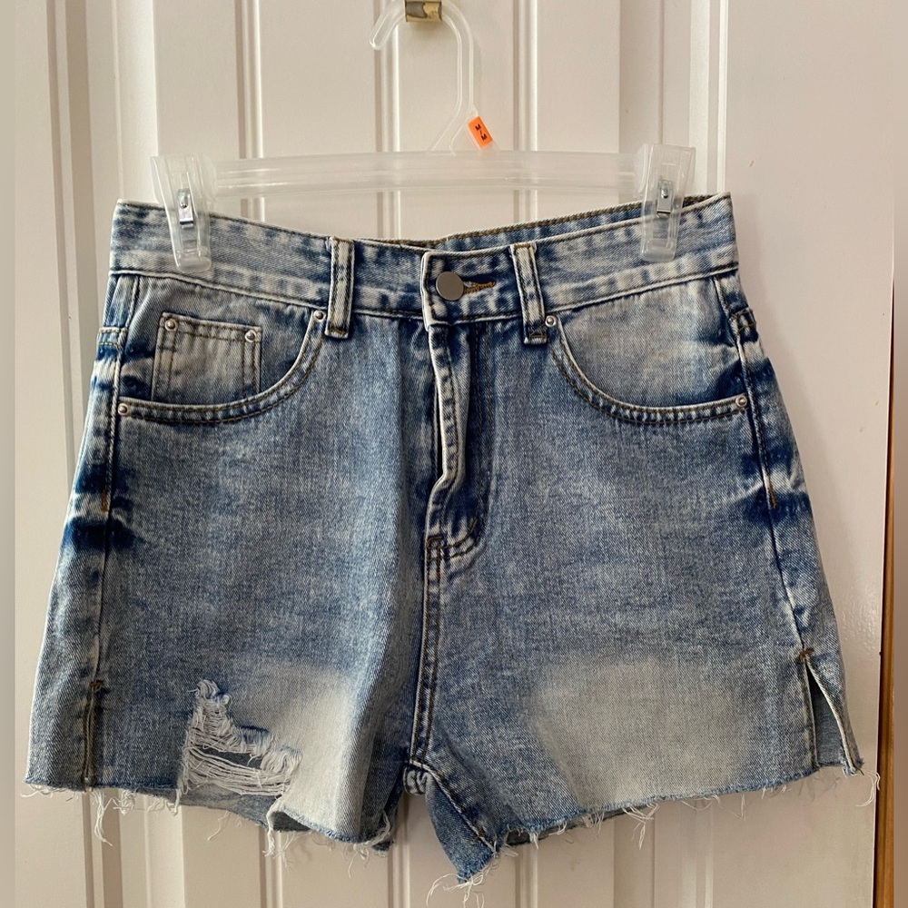 Distressed denim shorts with side slits